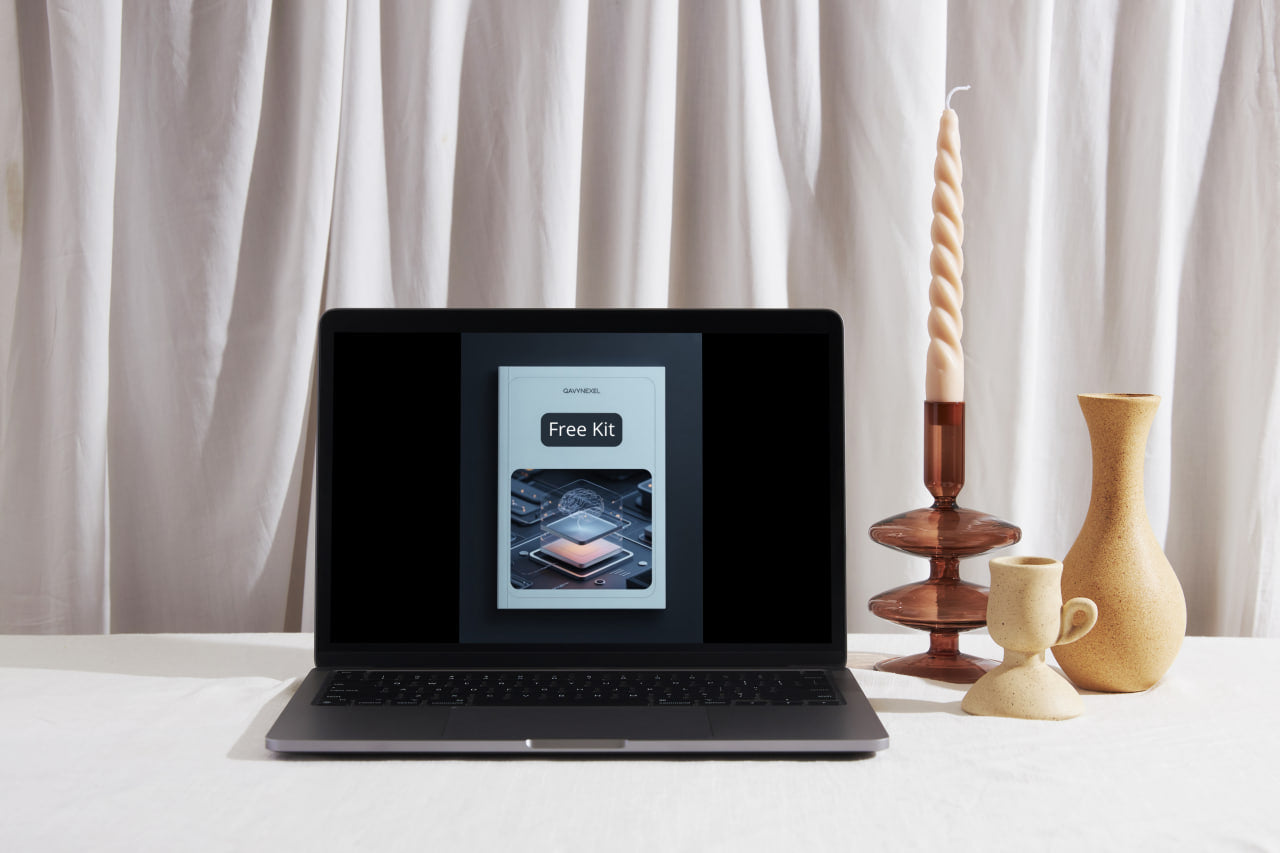 Laptop on a table with a screen displaying 'Free Kit' and decorative items in the background.
